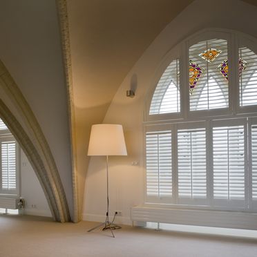 Tall_arched_white_shutters